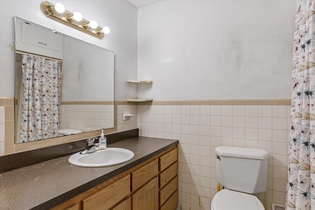 bathroom featuring tile walls, toilet, and vanity