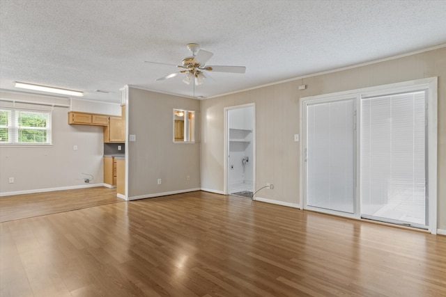 unfurnished living room featuring wood-type flooring, a textured ceiling, and ceiling fan