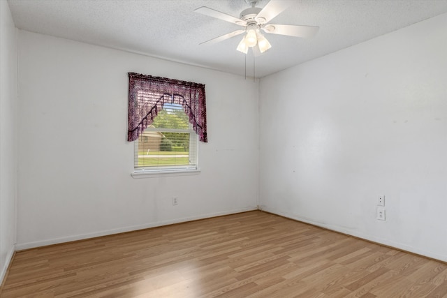 empty room with a textured ceiling, light hardwood / wood-style flooring, and ceiling fan