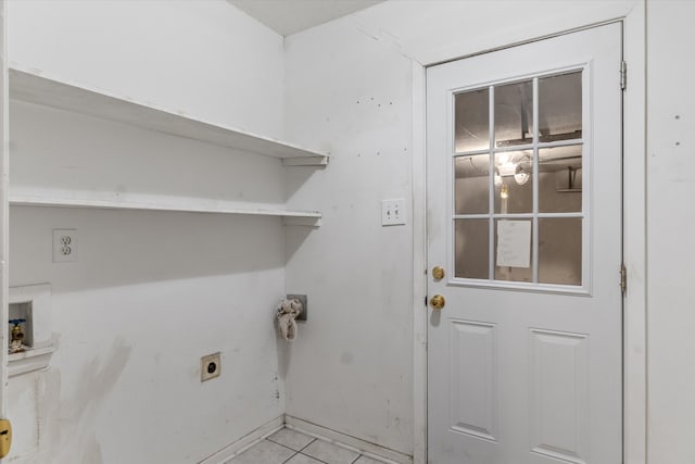 clothes washing area featuring light tile patterned floors, electric dryer hookup, and washer hookup