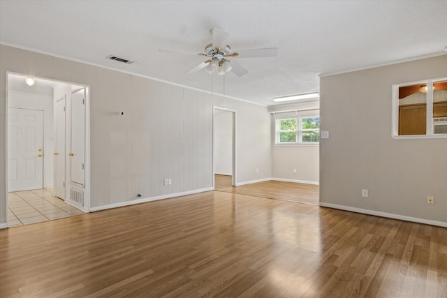 unfurnished room with light hardwood / wood-style floors, ceiling fan, and crown molding