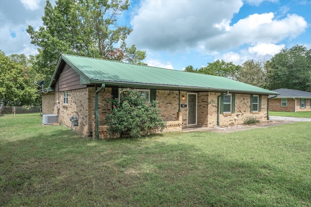 single story home with central AC and a front yard