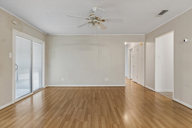 empty room featuring ornamental molding, a textured ceiling, ceiling fan, and light wood-type flooring