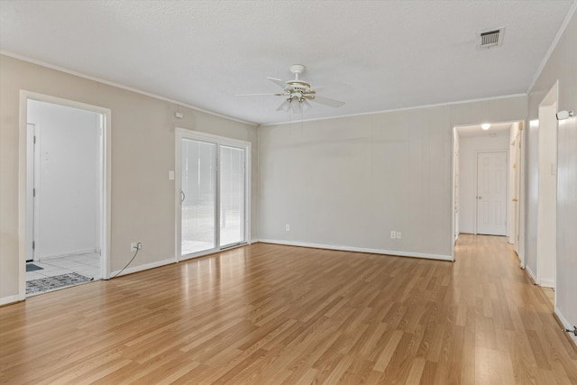 empty room with crown molding, light wood-type flooring, ceiling fan, and a textured ceiling