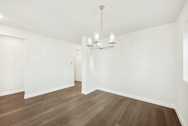 unfurnished dining area featuring dark hardwood / wood-style floors and a notable chandelier