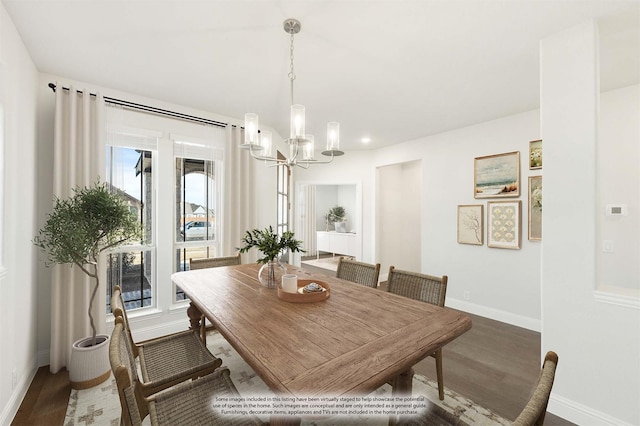 dining room with hardwood / wood-style flooring and a notable chandelier