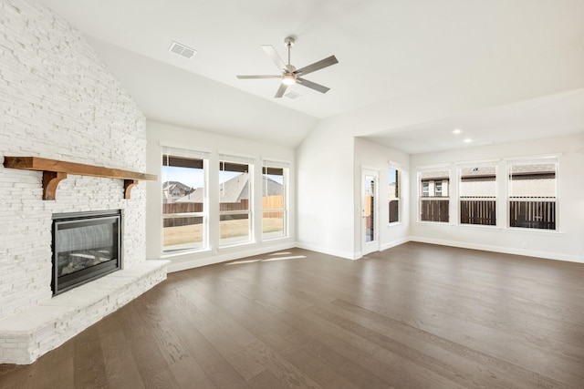 unfurnished living room with ceiling fan, a fireplace, dark hardwood / wood-style flooring, and vaulted ceiling