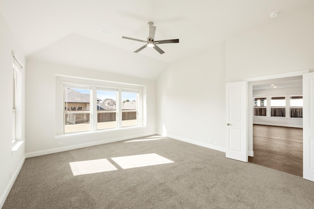 unfurnished living room with vaulted ceiling, ceiling fan, and carpet flooring