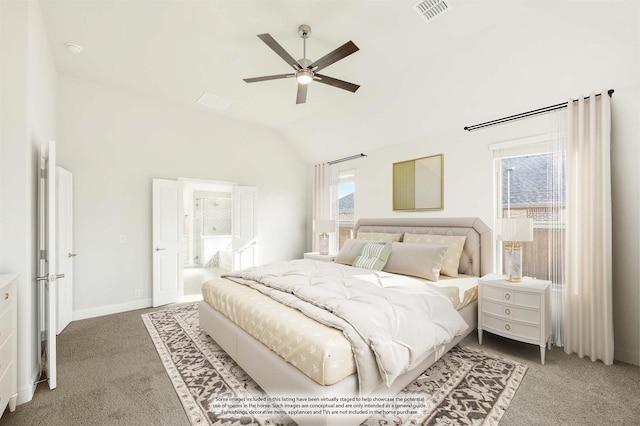 carpeted bedroom featuring vaulted ceiling, ceiling fan, and ensuite bath