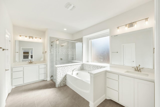 bathroom featuring tile patterned flooring, vanity, and separate shower and tub