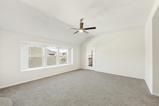 unfurnished room with lofted ceiling, carpet flooring, and ceiling fan