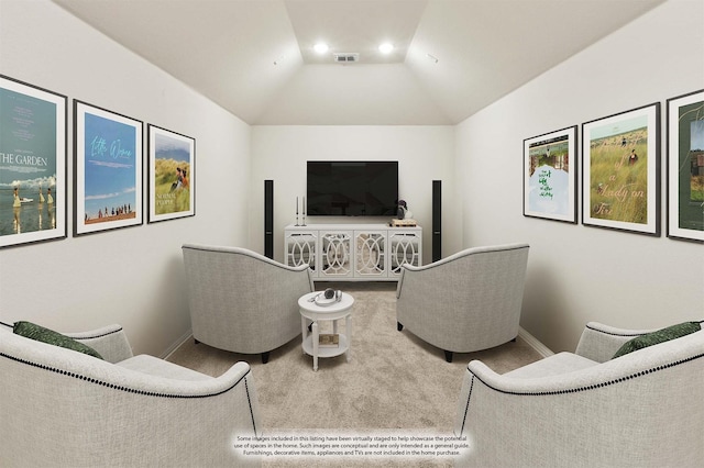 carpeted living room with lofted ceiling