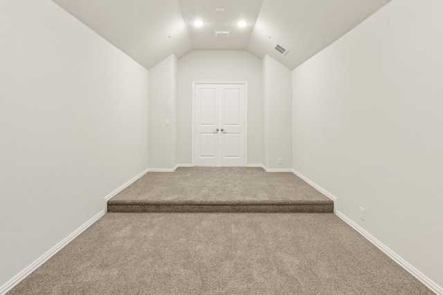 bonus room featuring carpet flooring and vaulted ceiling