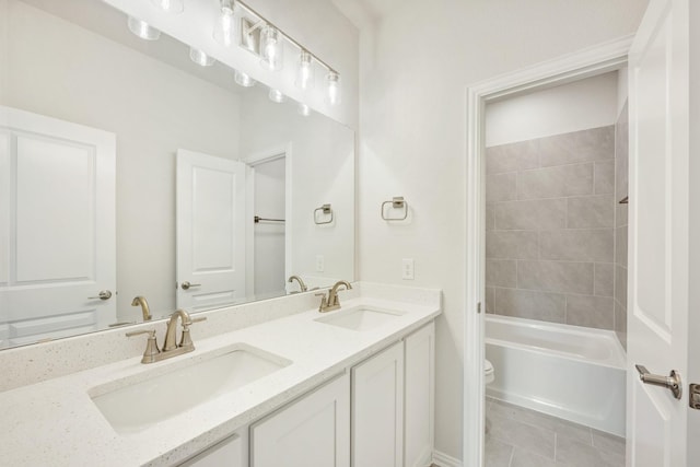 full bathroom featuring vanity, toilet, tiled shower / bath combo, and tile patterned flooring