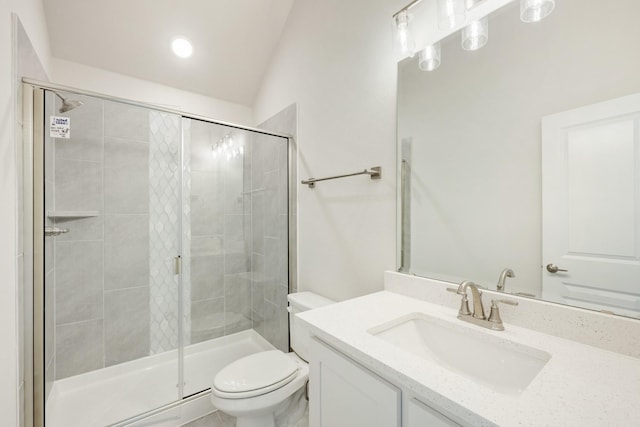 bathroom with vanity, lofted ceiling, toilet, and walk in shower