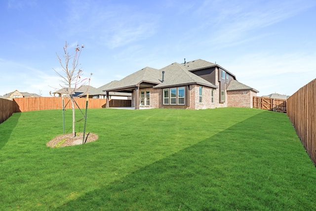 rear view of house with a lawn