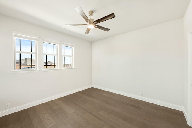 empty room featuring dark hardwood / wood-style floors and ceiling fan