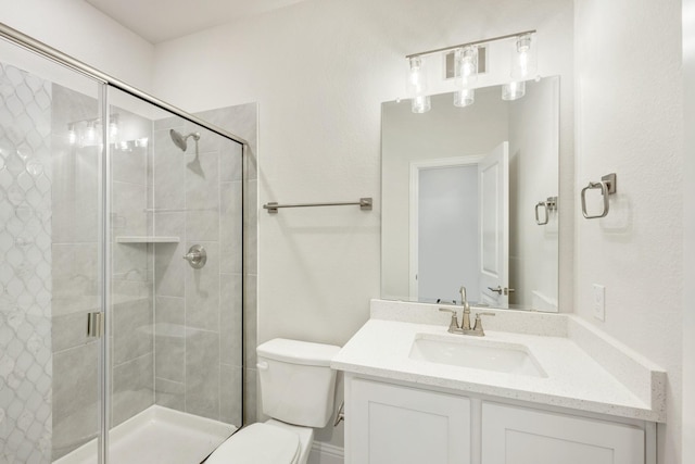 bathroom featuring walk in shower, vanity, and toilet