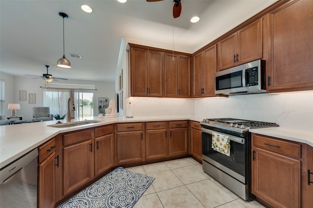 kitchen with light tile patterned floors, ceiling fan, appliances with stainless steel finishes, decorative backsplash, and sink