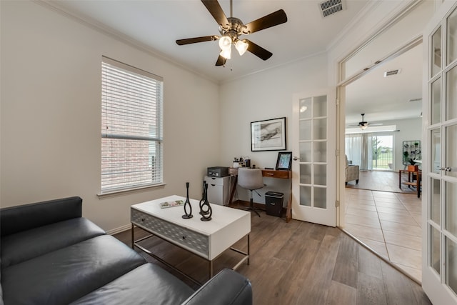 living room with hardwood / wood-style flooring, french doors, ornamental molding, and ceiling fan