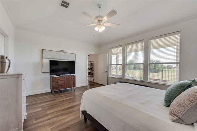 bedroom featuring ceiling fan, crown molding, hardwood / wood-style flooring, and vaulted ceiling