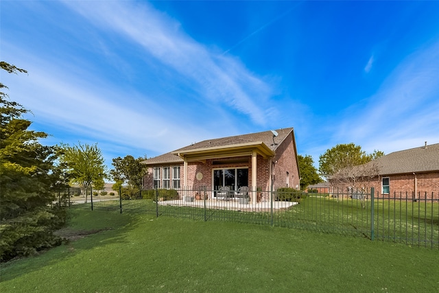 back of house featuring a yard and a patio area