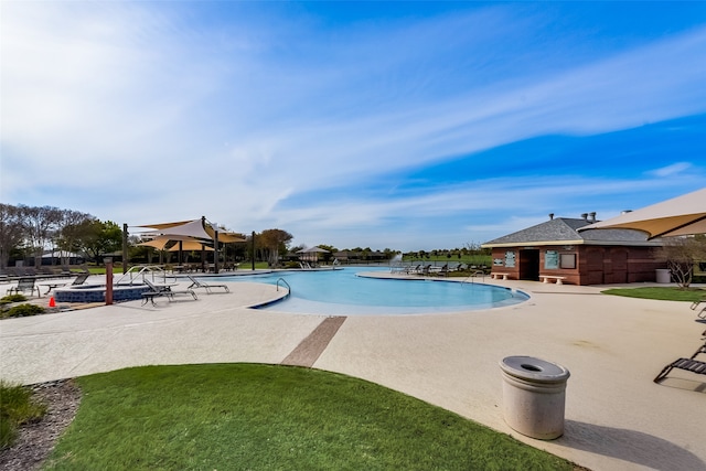 view of swimming pool featuring a patio area