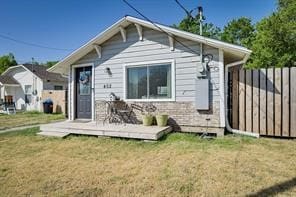 back of property featuring a deck and a yard