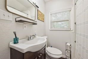 bathroom featuring toilet and vanity