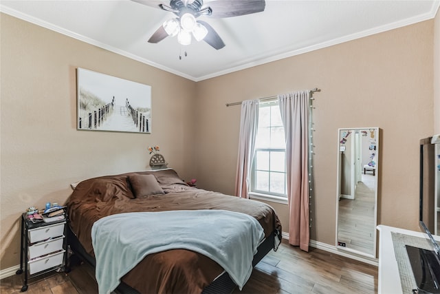 bedroom with ornamental molding, hardwood / wood-style floors, and ceiling fan