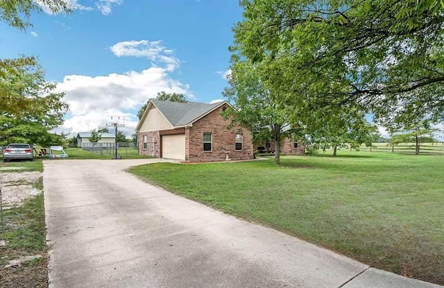 view of side of property with a garage and a yard