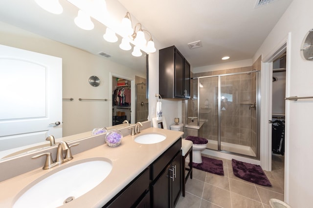 bathroom with tile patterned flooring, vanity, walk in shower, toilet, and an inviting chandelier