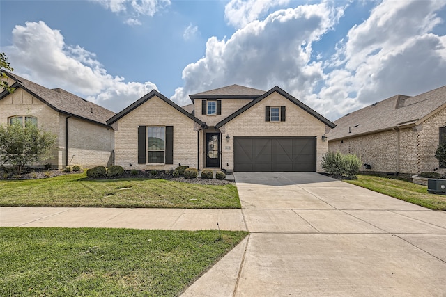 view of front of property with a garage and a front lawn