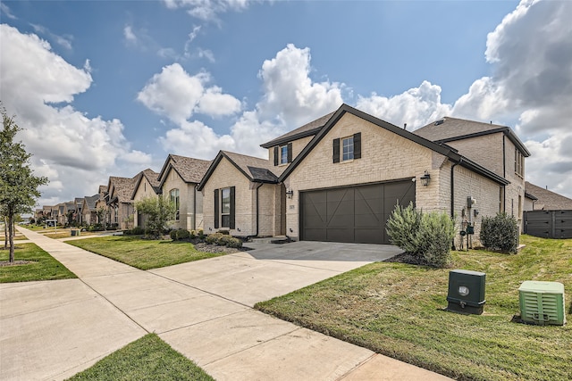 view of front of house featuring a garage and a front lawn