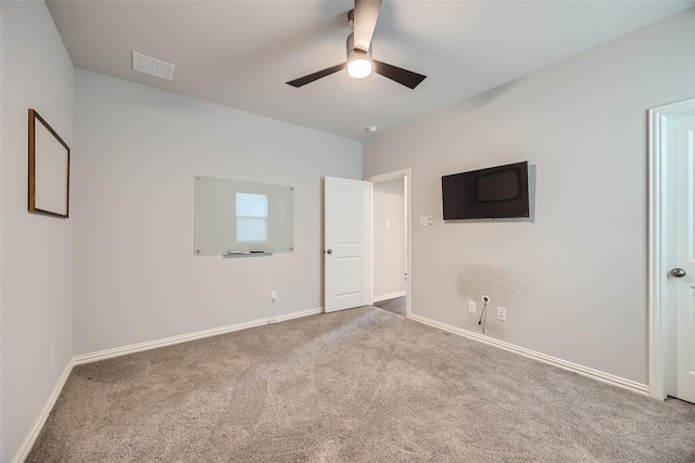 empty room featuring ceiling fan and carpet flooring