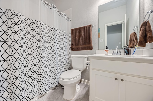 bathroom with vanity, tile patterned flooring, and toilet