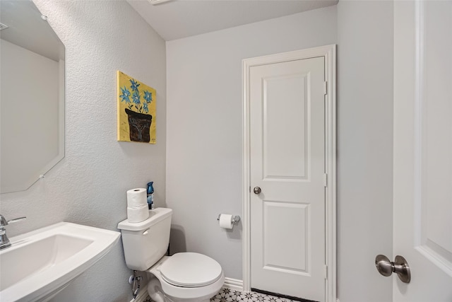 bathroom featuring sink and toilet