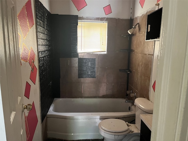 full bathroom featuring toilet, vanity, and tiled shower / bath