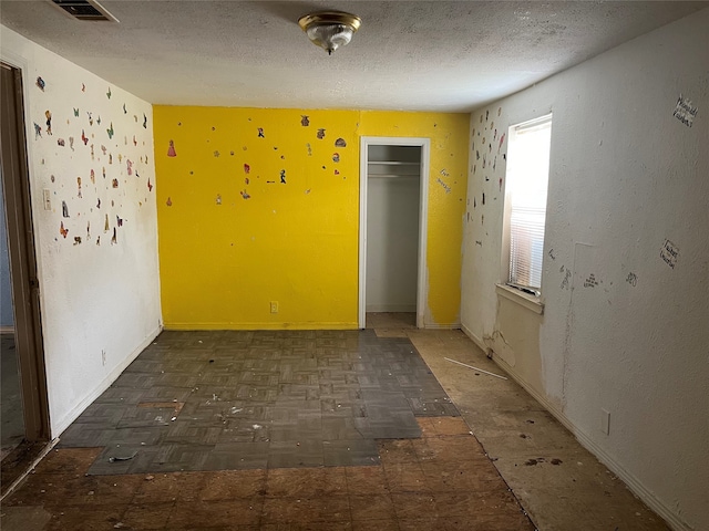 empty room with a textured ceiling