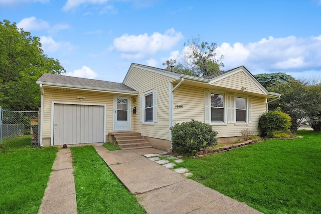 ranch-style house featuring a garage and a front yard