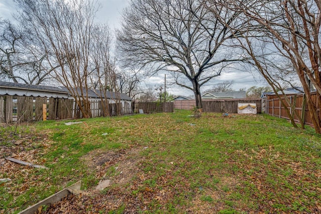 view of yard with a fenced backyard