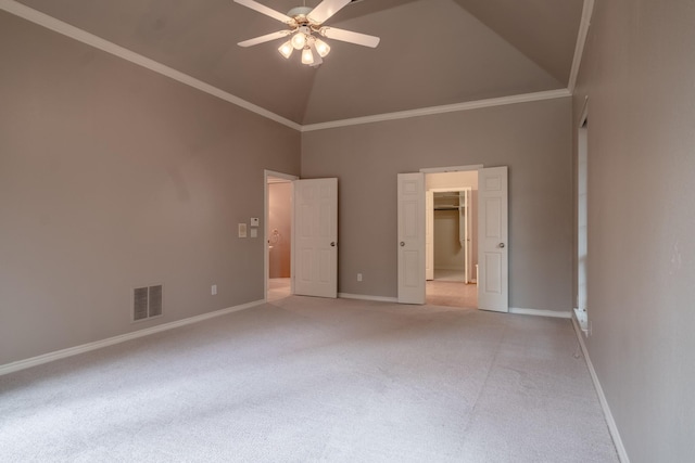 unfurnished bedroom with a spacious closet, crown molding, high vaulted ceiling, light carpet, and ceiling fan