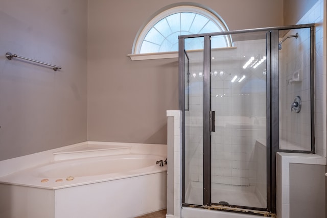 bathroom featuring independent shower and bath