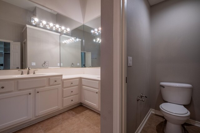 bathroom with vanity, toilet, and tile patterned flooring