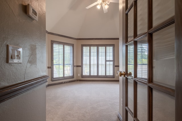 carpeted empty room featuring lofted ceiling and ceiling fan