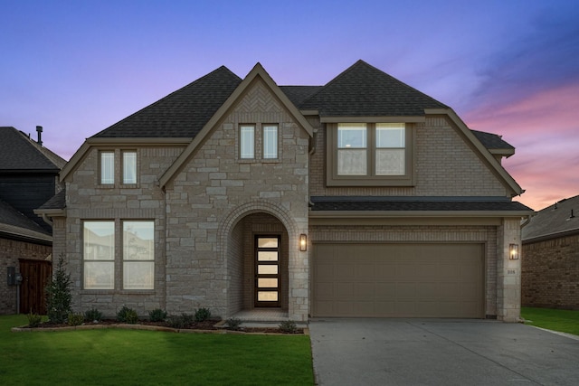 view of front facade with a garage and a yard