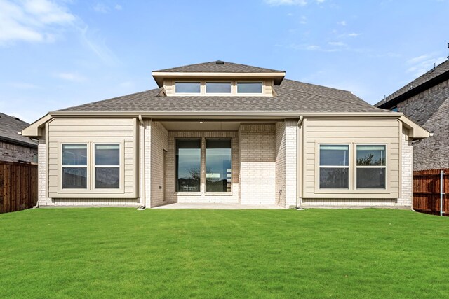 back of house featuring a lawn