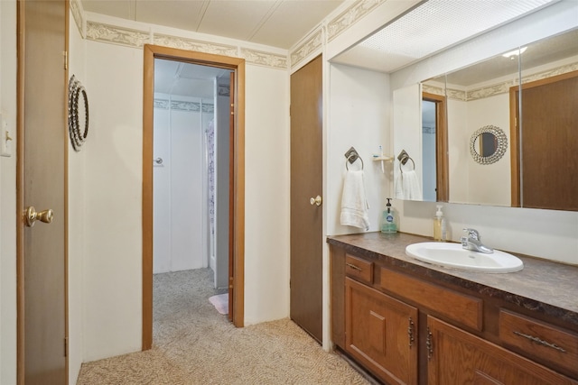 bathroom featuring ornamental molding and vanity