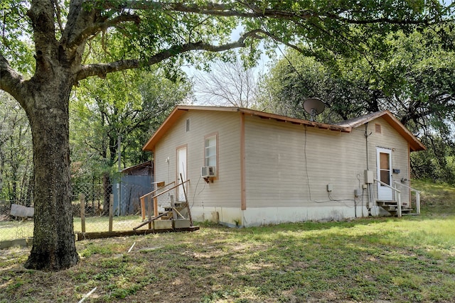 view of side of property with cooling unit