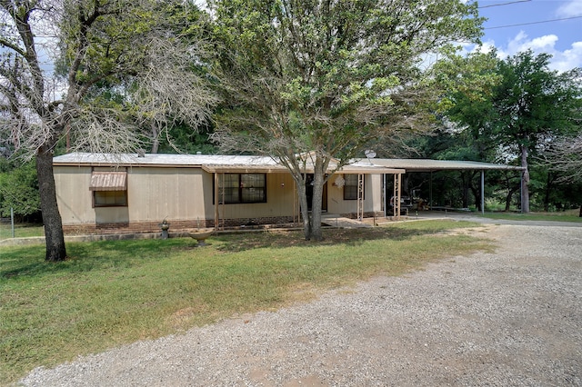 view of front of property with a front yard and a carport